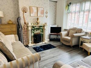 a living room with a couch and a fireplace at The First-central Wigan 8 guests in Wigan