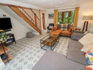 a living room with a couch and a table at Rudbaxton Water in Haverfordwest