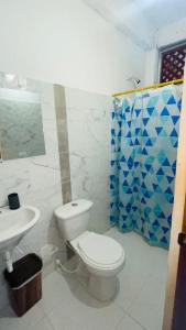 a bathroom with a toilet and a sink at Hotel talú tayrona in El Zaino