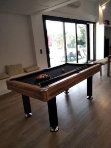 a pool table sitting in a living room with at Finca El Pilar in Madridejos