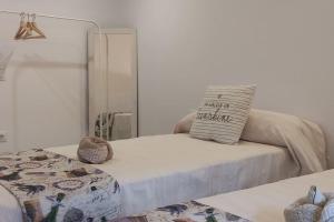 a white bedroom with a bed with a mirror at Finca El Pilar in Madridejos