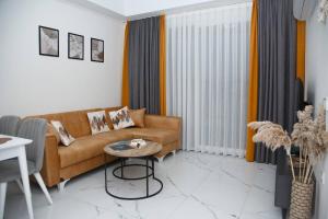 a living room with a couch and a table at Art Life apartments BOHO in Alanya