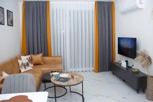a living room with a couch and a table at Art Life apartments BOHO in Alanya +52 photos