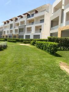 an apartment building with a lawn in front of it at The Groove Ain Sokhna in Ain Sokhna