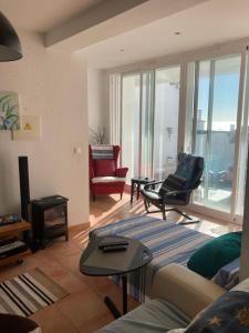 a living room with a couch and chairs at Casa Praia do Sul in Ericeira