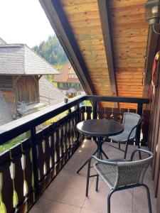 a patio with two chairs and a table on a balcony at Forest Apartment in St. Blasien