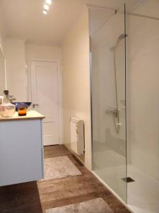 a bathroom with a shower with a glass door at IAROS El Coto in Mogro +3 photos