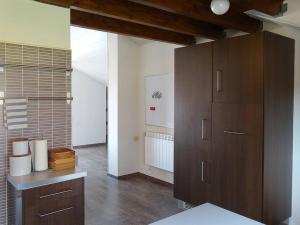 a large kitchen with wooden cabinets in a room at IAROS El Coto in Mogro