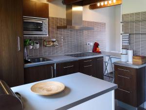 a kitchen with a white counter top with a sink at IAROS El Coto in Mogro