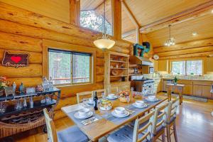 a dining room with a table and chairs in a cabin at Bend Getaway with Private Hot Tub and Cozy Fireplace in Bend