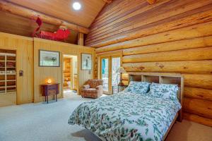 a bedroom with a bed in a log cabin at Bend Getaway with Private Hot Tub and Cozy Fireplace in Bend
