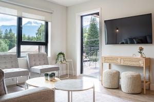 a living room with a couch and a tv at Western Star by Revelstoke Vacations in Revelstoke