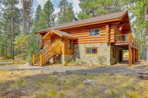 a log cabin in the woods with a staircase at Bend Getaway with Private Hot Tub and Cozy Fireplace in Bend