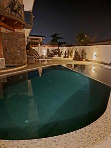 a swimming pool in a house at night at Villa Elisabetta in Pompei