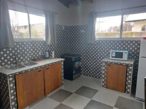a kitchen with a sink and a stove at Emilia II in Esquel