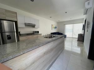 a kitchen with a sink and a counter top at Depto. totalmente nuevo y amueblado in Mazatlán