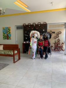 two people dressed in costumes standing in a room at Hotel Portal Triunfo in Triunfo