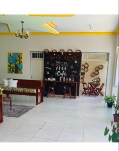 a room with a chalkboard with a table and chairs at Hotel Portal Triunfo in Triunfo