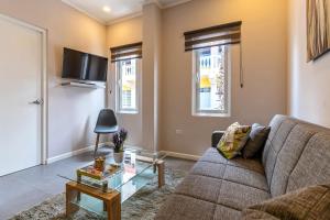 a living room with a couch and a table at Apt 27 CityLife Aruba in Oranjestad