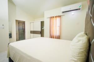 a bedroom with a white bed and a window at home with relaxing sea view in Discovery Bay