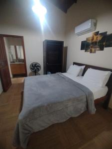 Säng eller sängar i ett rum på Pousada Casa no Sitio