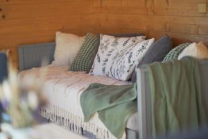 a bed with pillows on it in a room at Chata louka in Plzeň