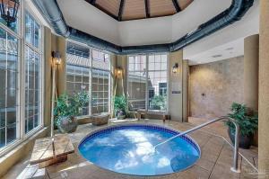 a large bathroom with a tub in a room with windows at Portofino Island Resort 4-1305 in Pensacola Beach