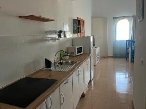 a kitchen with a sink and a counter top at La Vista Bonita in Corralejo