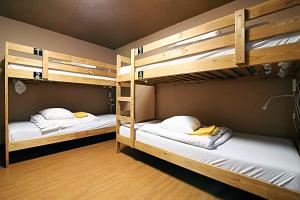 two bunk beds in a room with white pillows at TOKYO HOUSE INN - Vacation STAY 52051v in Tokyo