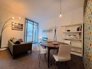 a living room with a table and a couch at Tulle - quartier historique in Tulle