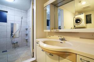 a bathroom with a sink and a shower with a mirror at TOKYO HOUSE INN - Vacation STAY 51871v in Tokyo