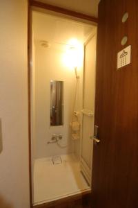 a bathroom with a shower with a light on the wall at TOKYO HOUSE INN - Vacation STAY 52042v in Tokyo