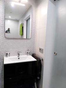 a bathroom with a sink and a mirror at SOL & MAR Playa de las vistas Torres del Sol A504 in Arona