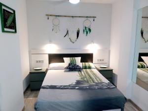 a bedroom with a large bed with two night stands at SOL & MAR Playa de las vistas Torres del Sol A504 in Arona +43 photos