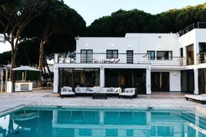 a house with a pool in front of it at Villa GAULTHIER in Marbella
