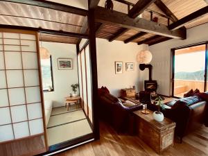 a japanese living room with a large glass doorway at Snowman apartments - Vacation STAY 15949v in Iiyama