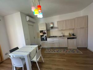 a kitchen with a table and chairs and a kitchen with a stove at Il Riccio in Bari +12 photos