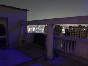 balcón con vistas a la ciudad por la noche en Female Room only with a nile view roof, en El Cairo