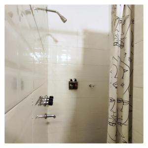 a bathroom with a shower with a shower curtain at CASA TRANSFORMER in Córdoba