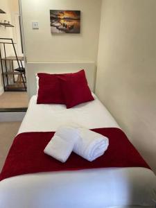 a bed with two white towels on top of it at Charter House with good Wifi in Chatham