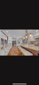 a large kitchen with long counters and white cabinets at Resort type home in Old Brookvile !!! in Glen Head