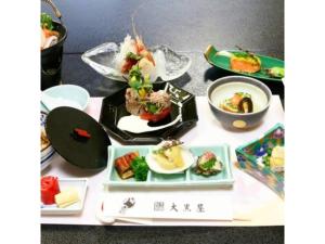 a table with several plates of food on it at Daikokuya Ryokan - Vacation STAY 53558v in Hakodate