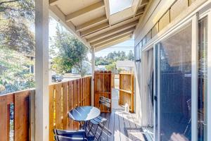 a patio with a table and chairs on a porch at The Coos-Coos Nest in North Bend