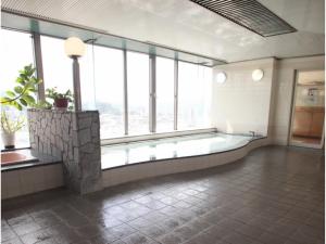 un ampio bagno con una grande vasca con finestre di Hotel Socia - Vacation STAY 53739v a Hita