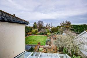 a view of the garden from the roof of a house at A Quaint and Delightful Abode in Normanhurst in Carshalton