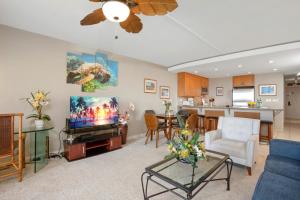 a living room with a flat screen tv and a kitchen at KBM Resorts KVR-F405 1 bdrm Includes Rental Car in Kaanapali