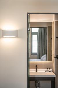 a bathroom with a sink and a mirror at La Torre del Kastelli in Chania Town +179 photos