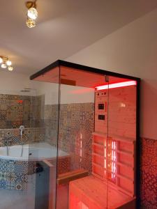 a bathroom with a tub and a glass shower at Landhaus Grünjuwel in Himmelberg