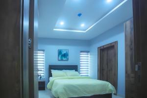 a bedroom with a bed with a blue led ceiling at Picturesque 3-bedroom Apartment in Yaba in Lagos