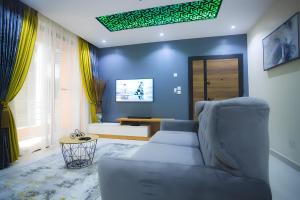a living room with a couch and a table at Picturesque 3-bedroom Apartment in Yaba in Lagos
